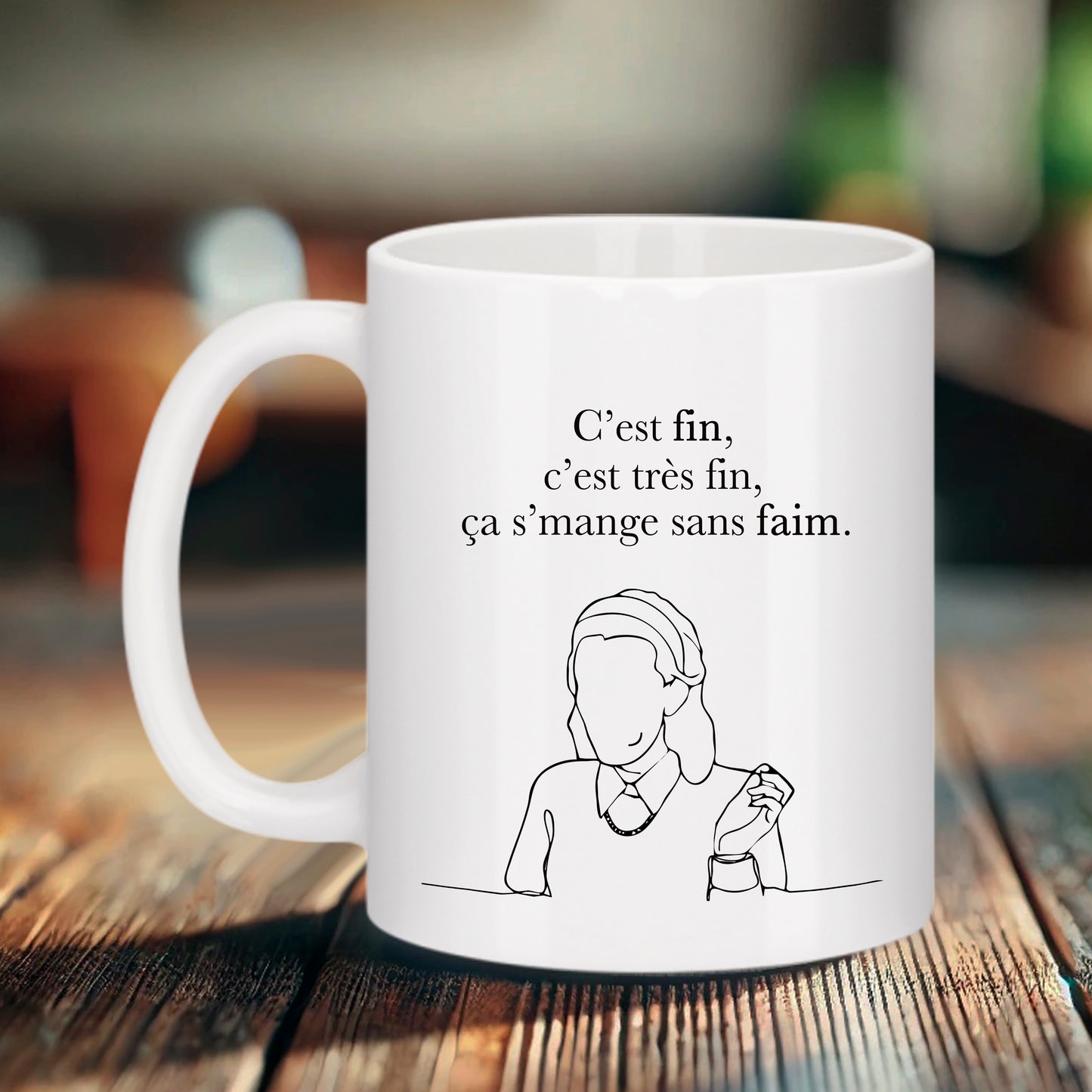 Mug blanc Bruhle avec illustration en traits noirs d'une femme de profil et le texte "C'est fin, c'est très fin, ça s'mange sans faim."