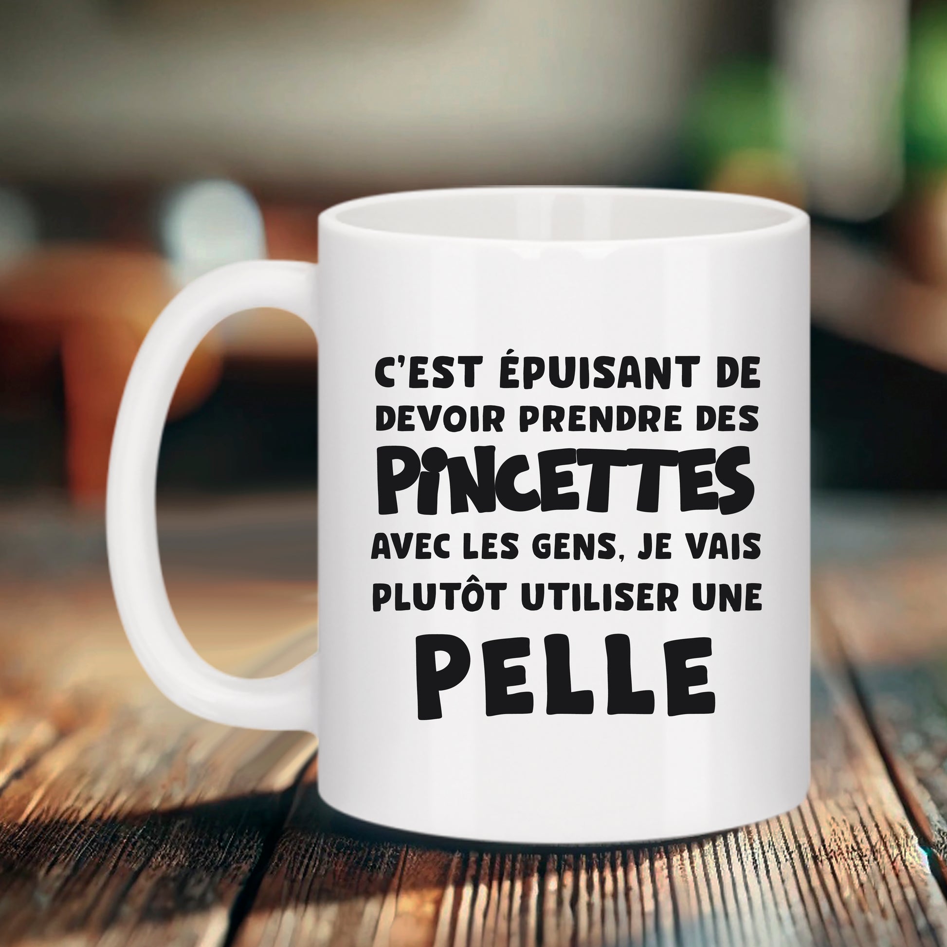 Mug blanc Bruhle avec texte noir humoristique : C'est épuisant de devoir prendre des pincettes avec les gens, je vais plutôt utiliser une PELLE écrit en gros.