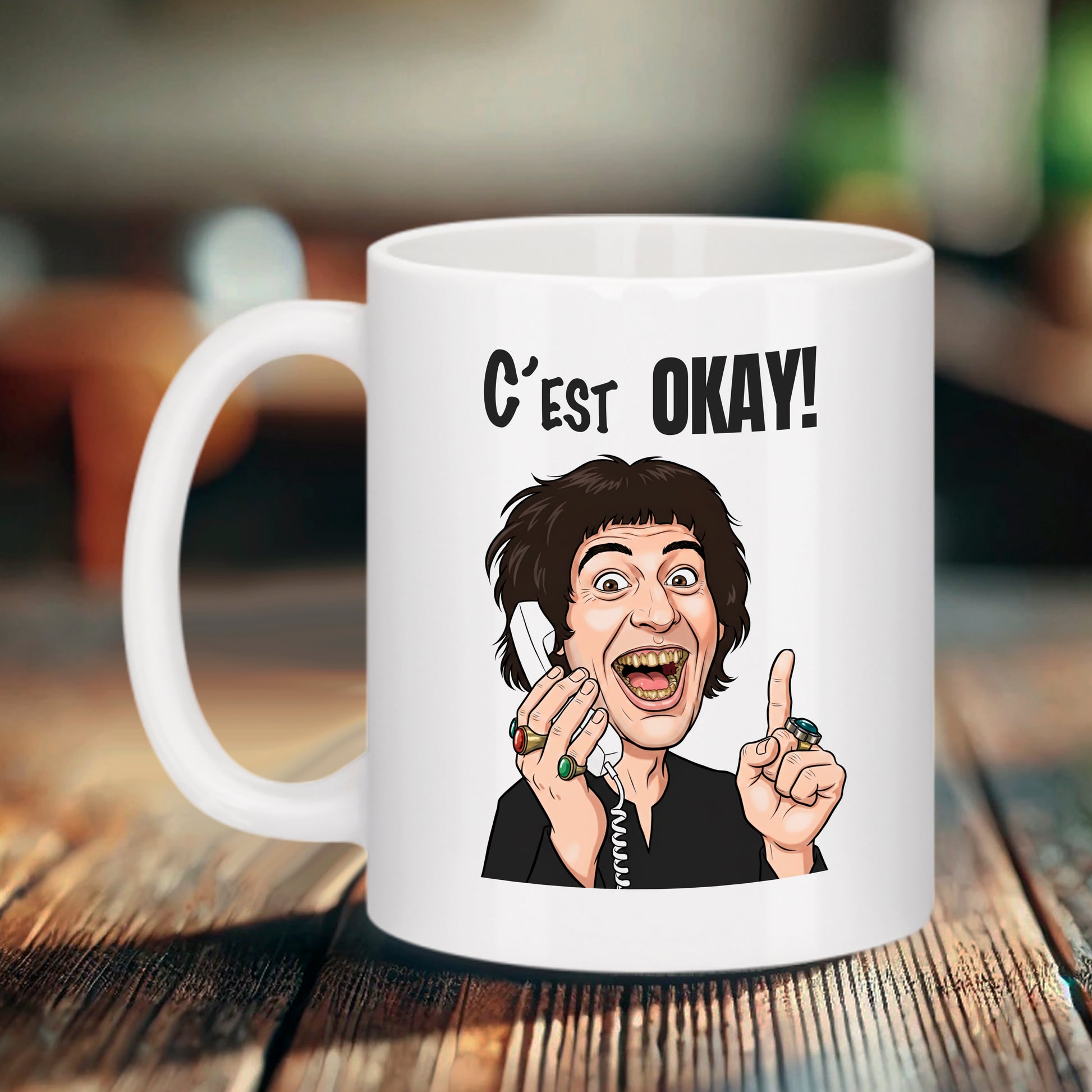 Mug blanc Bruhle avec une caricature de Jacquouille la Fripouille tenant un combiné téléphonique blanc et le texte noir C'EST OKAY !