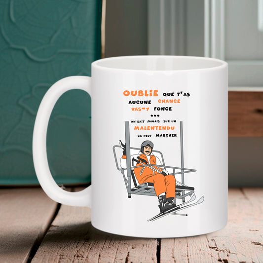 Mug blanc Bruhle avec illustration d'un skieur sur un télésiège et texte "Sur un malentendu ça peut marcher".