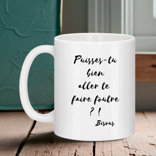 Mug blanc Bruhle avec une inscription en écriture cursive noire : Puisses-tu bien aller te faire foutre ?! Bisous.